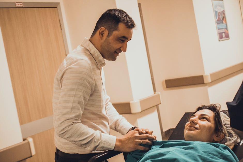 Healthcare professional supporting a patient in a hospital corridor