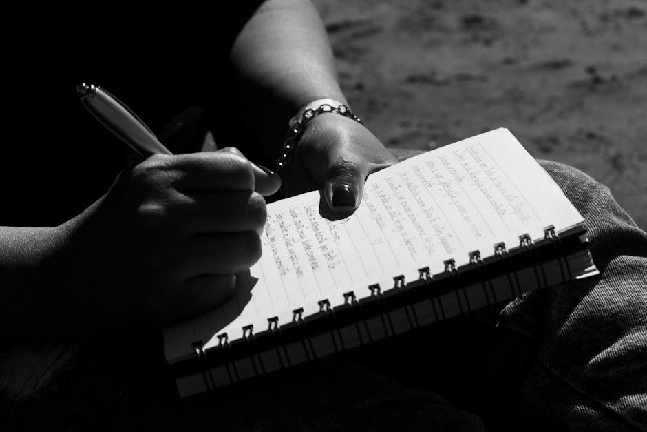 Person writing in a journal to track emotions and triggers