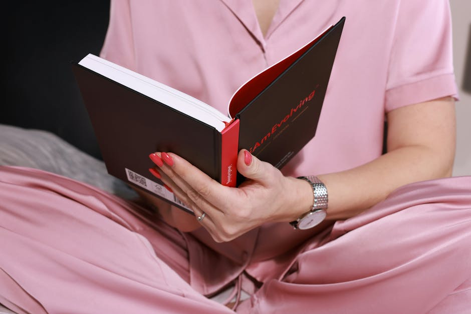 Person writing in a notebook at night, symbolizing dream journaling and self-reflection