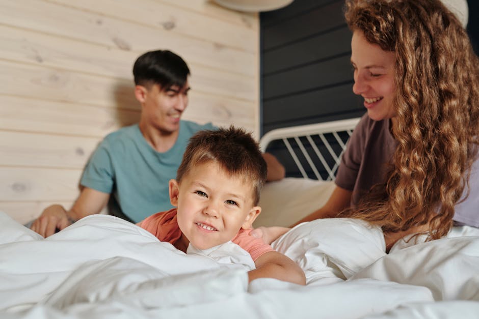 Young child sitting between mother and father in a family home