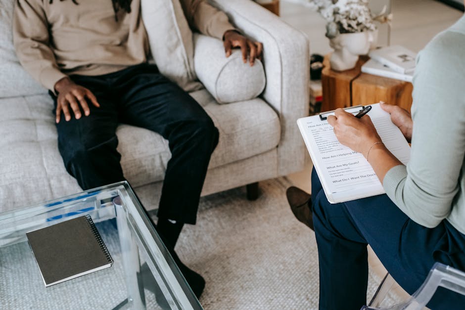 Therapist and patient in a psychoanalysis consultation room with a couch