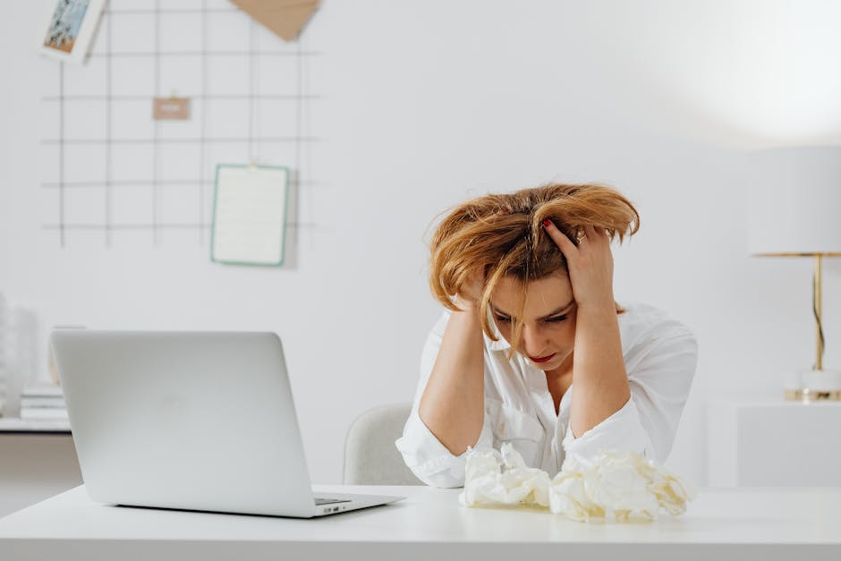 Person sitting alone in a dim office, reflecting on toxic workplace relationships