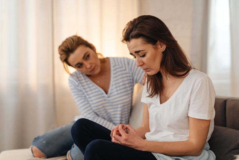 Two people having a supportive conversation in a bright room