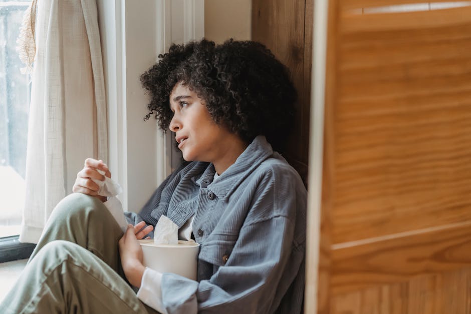 Person feeling stressed and isolated in a social setting