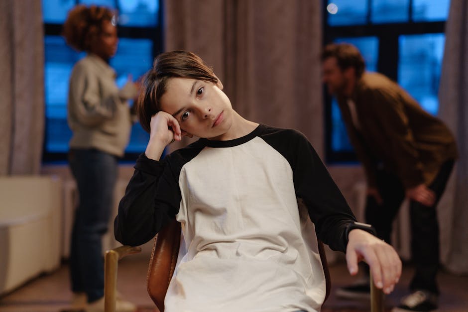 Child sitting alone with distant parent in a tense family scene
