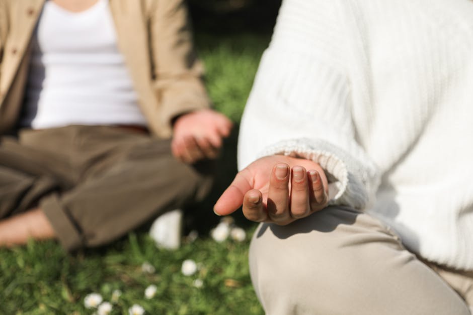 Person practicing mindful breathing in a calm natural setting