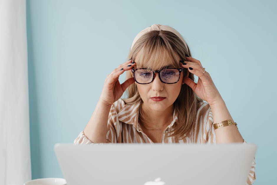 Office worker taking a mindful pause at work, sitting calmly before a laptop