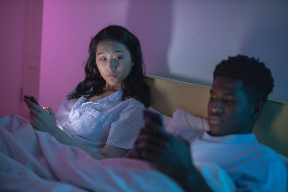 Woman looking at phone anxiously in a controlling relationship