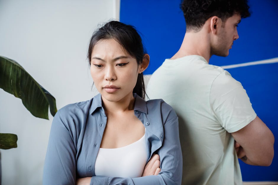 Couple in tense emotional conflict with one partner feeling isolated