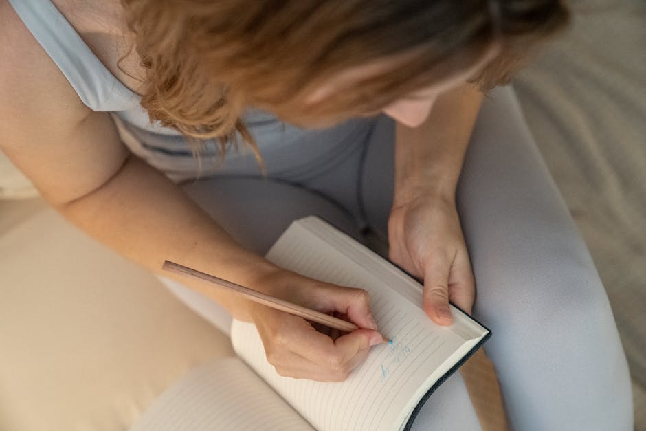 Person journaling to stop rumination and process emotions