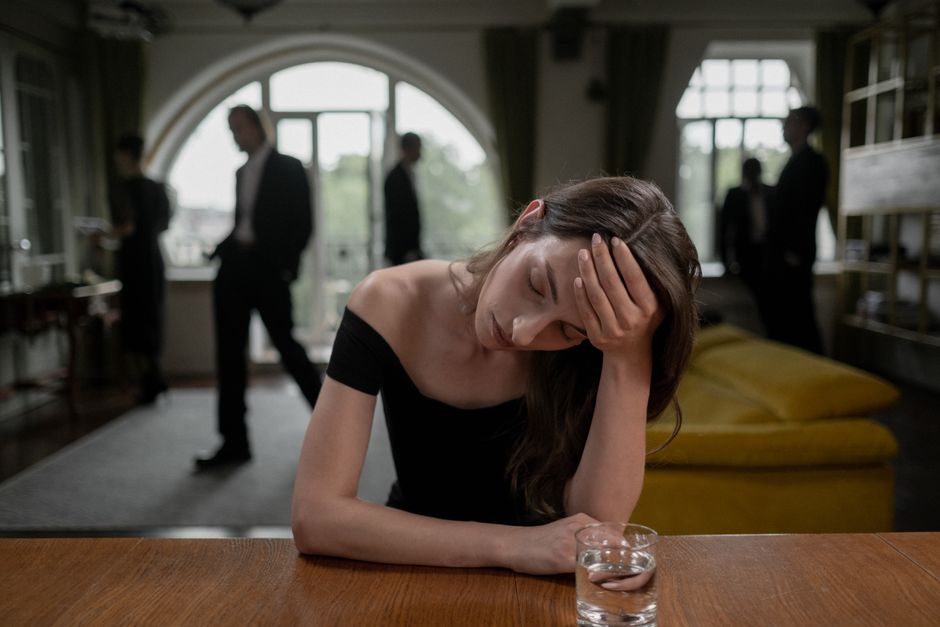 Stressed woman feeling overwhelmed in a family conversation