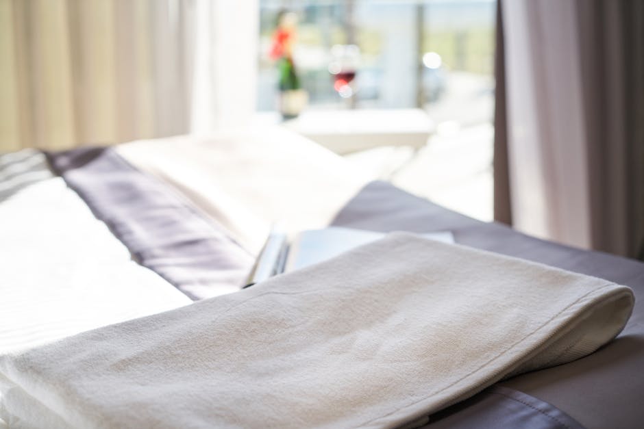 Morning routine with sunlight, open curtains and a glass of water on bedside table