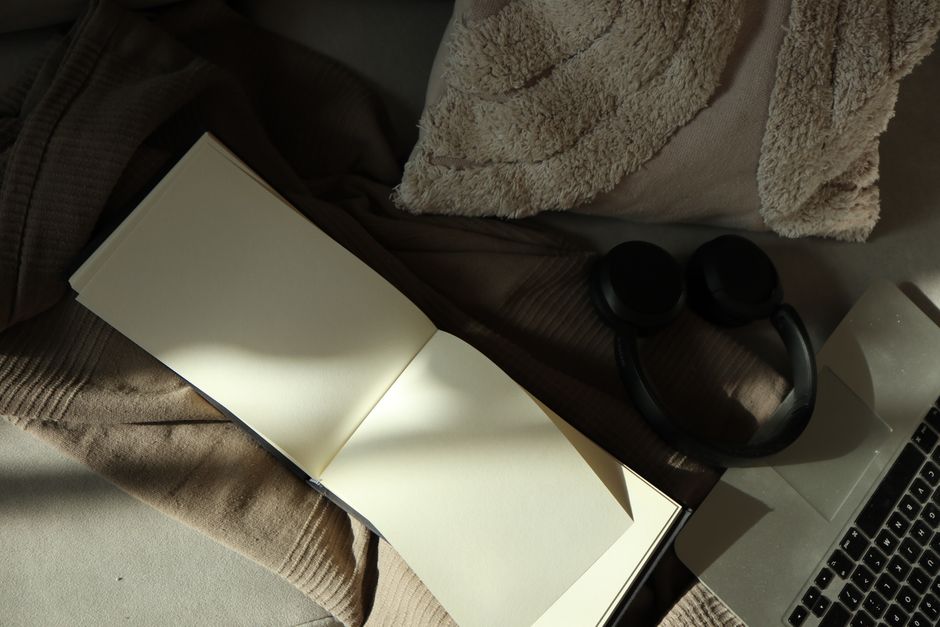 Person working alone in a calm creative space with notebook and laptop
