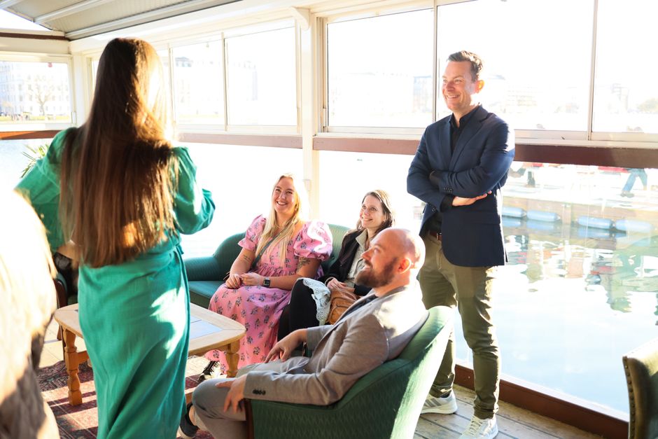 Two people having an animated conversation in a bright social setting