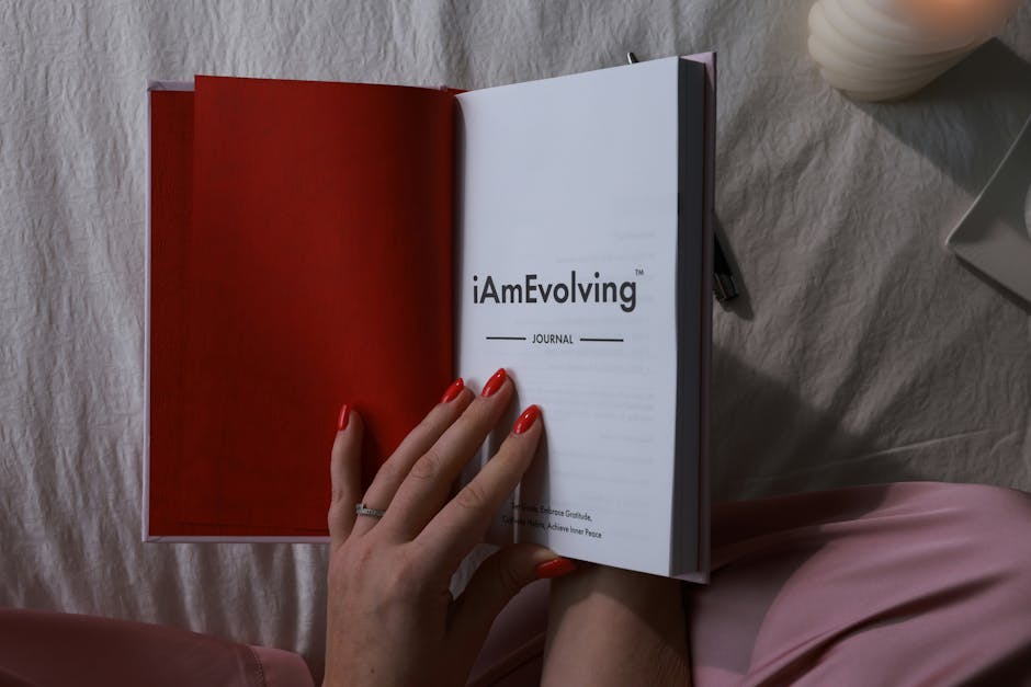Person writing in a journal for self-reflection and tracking progress