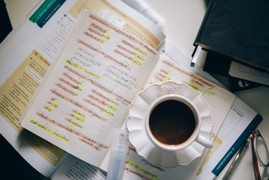 Person reading a psychology book with notes and highlighted pages