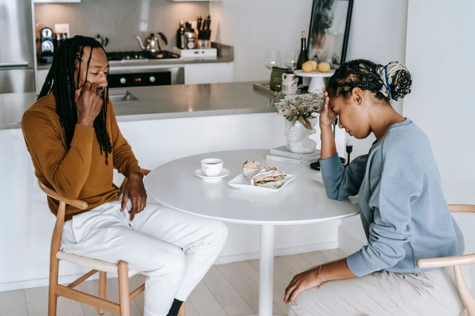 Two people in a tense conversation, symbolizing blame shifting and emotional manipulation