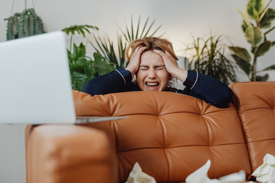 Person overwhelmed by emotions in a social setting