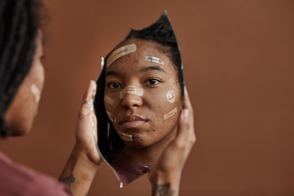 Anxious woman looking at her reflection in a mirror