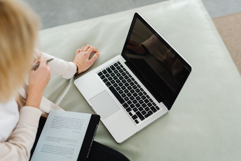 Person studying complex ideas with notebooks and laptop
