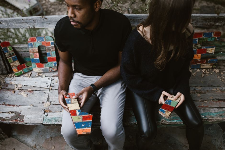Two people sitting apart on a couch, showing relationship tension and emotional disconnect