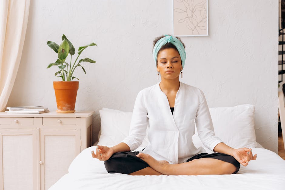 Person meditating in a quiet bedroom to reduce stress and anxiety