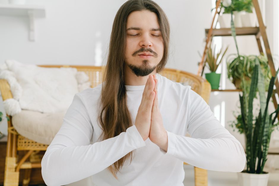 Calm person practicing mindfulness meditation in a quiet room