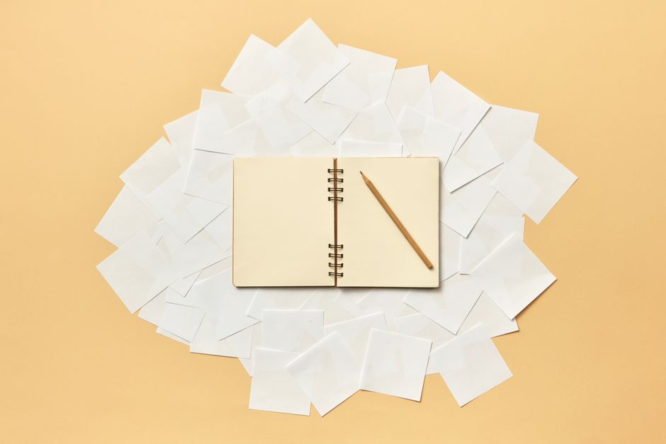 Person surrounded by sticky notes and self reflection journal