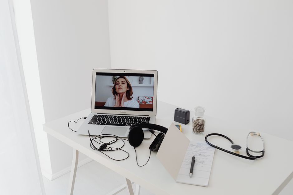 Online therapy video call on laptop in a home setting