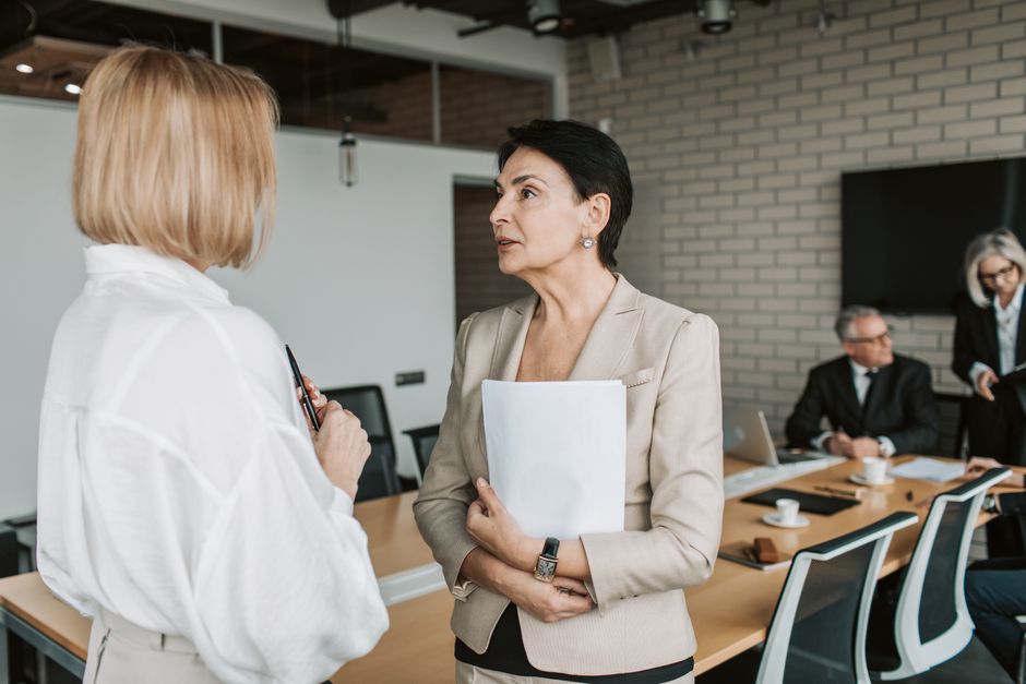 Two colleagues in a workplace discussion