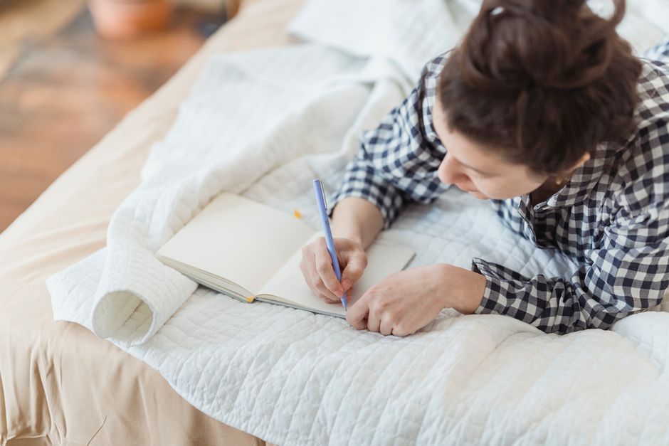 Person writing in a journal for self-reflection and values clarification