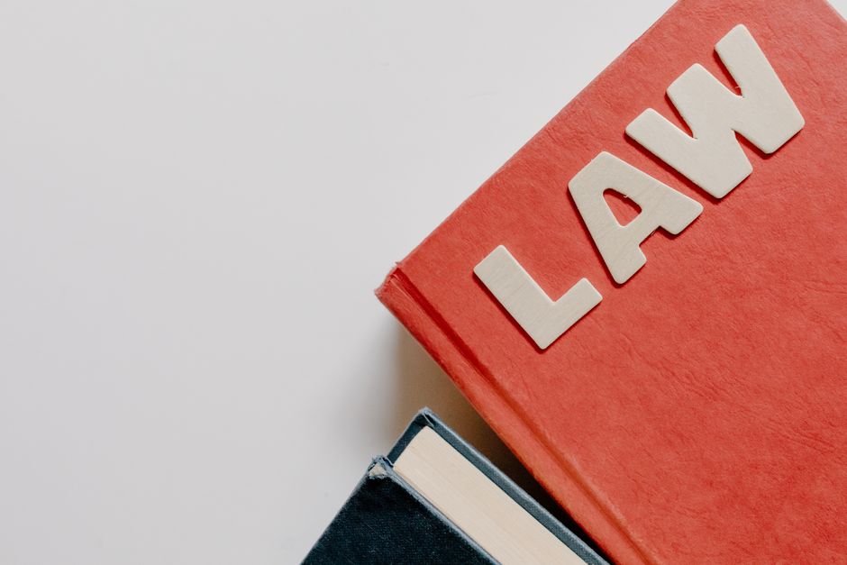 Stack of university textbooks and study materials on a desk