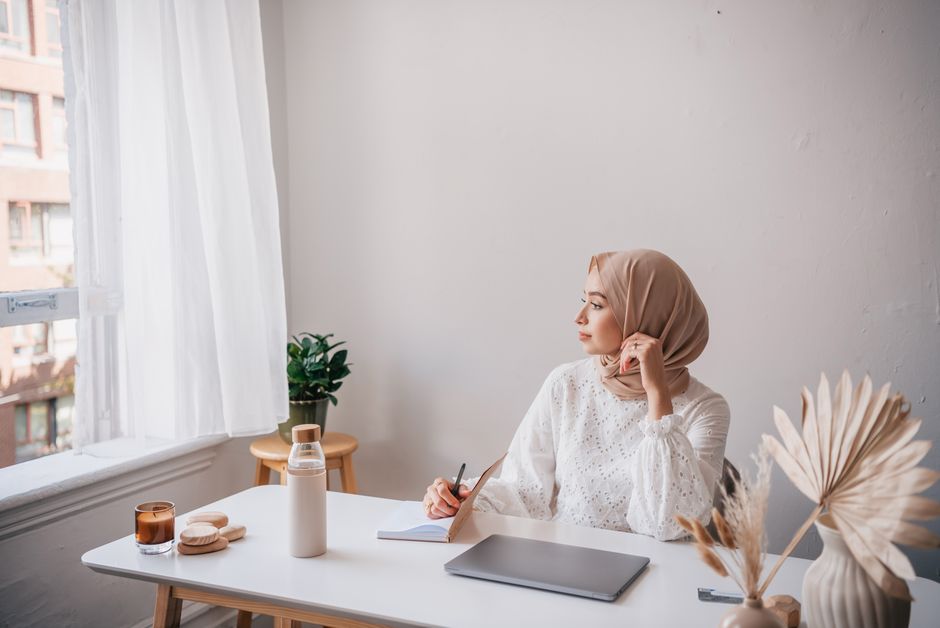 Person reflecting on identity and authenticity in a calm workspace