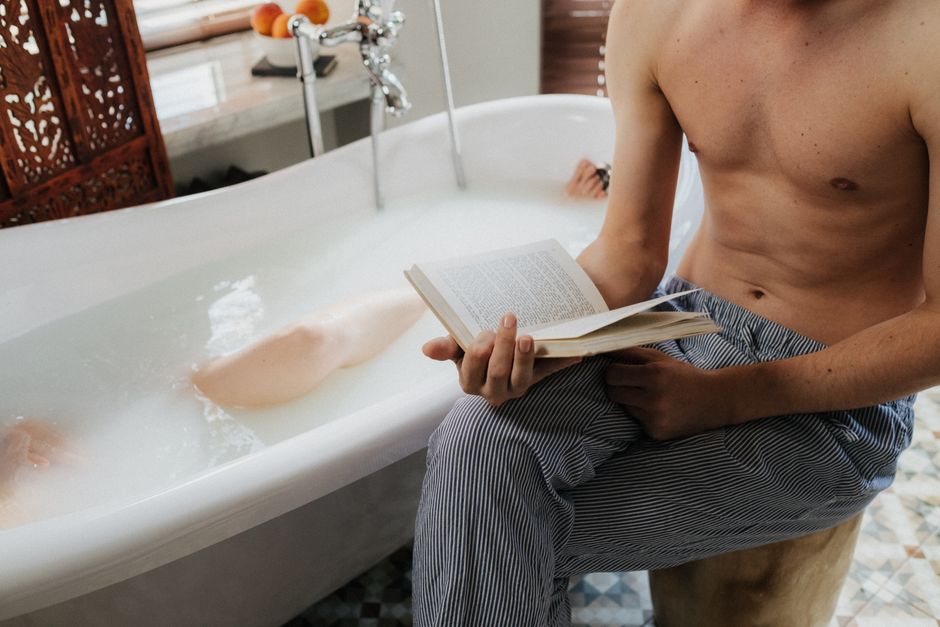 Woman reading about sexual health and body anatomy in a private setting