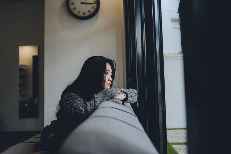 Person sitting alone in a room feeling anxious