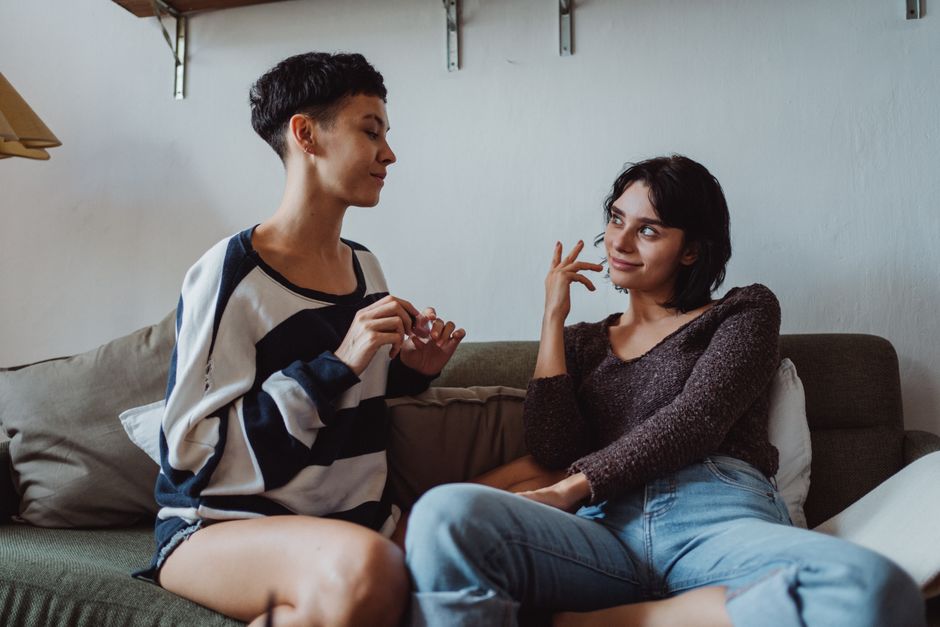 Two young adults sitting together in a casual intimate conversation