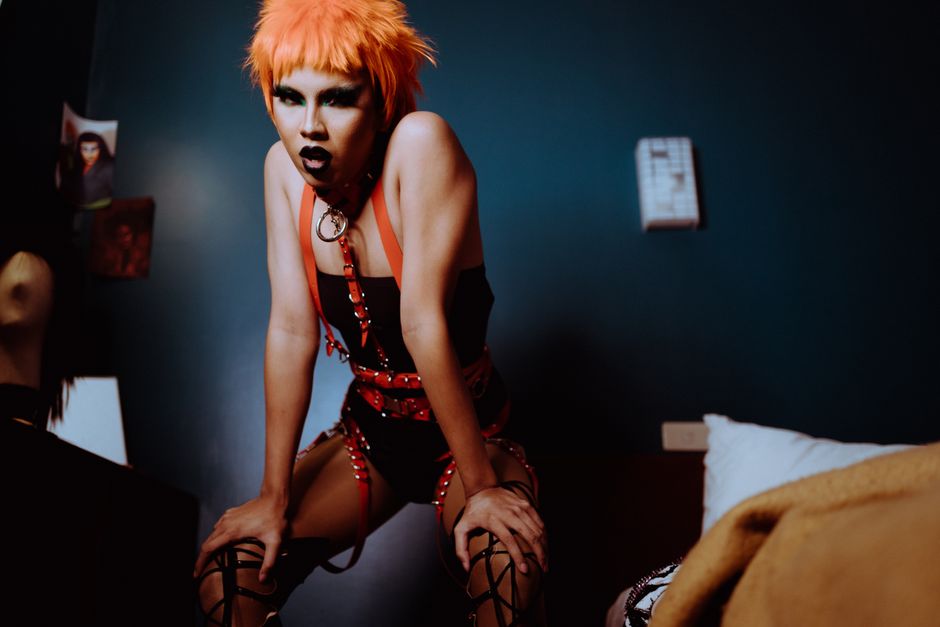 BDSM accessories on a dark bed, rope and leather cuffs