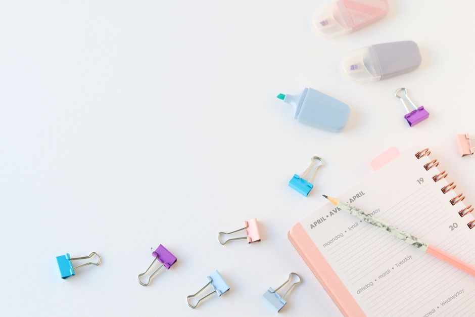 Calendar, notebook, and pen used to track mood and sleep patterns over time