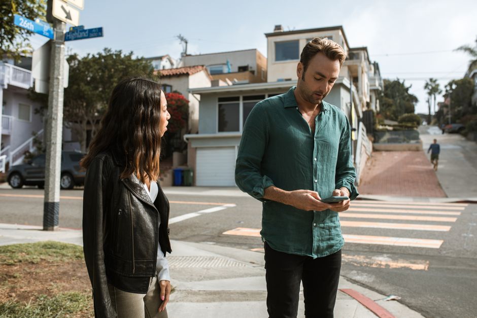 Couple in conflict with one partner checking a phone anxiously