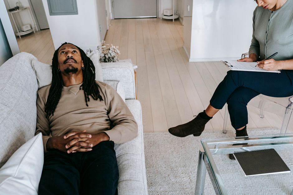 Person in a calm therapy session listening and speaking with a counselor