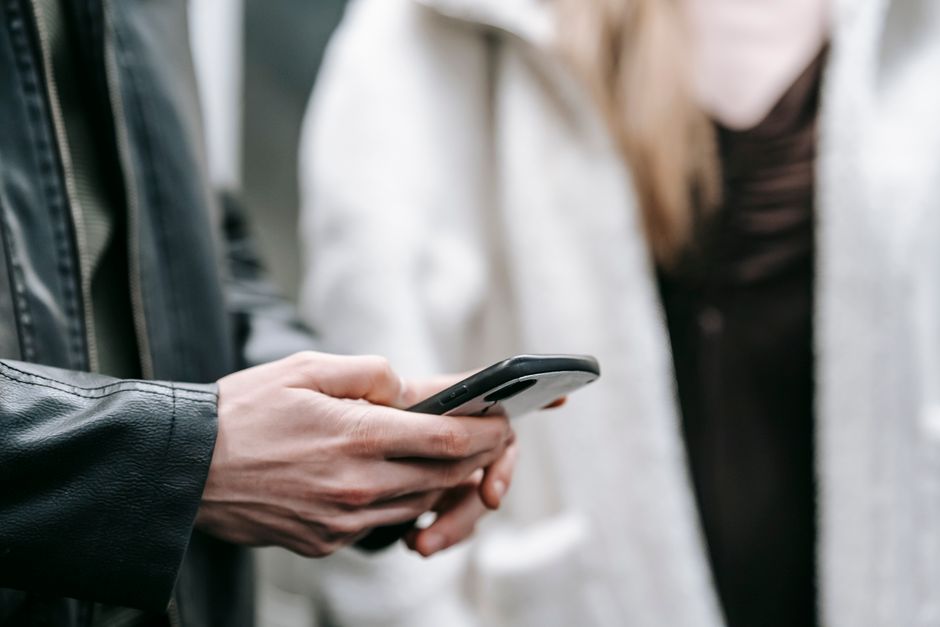 Woman looking at phone messages with concern