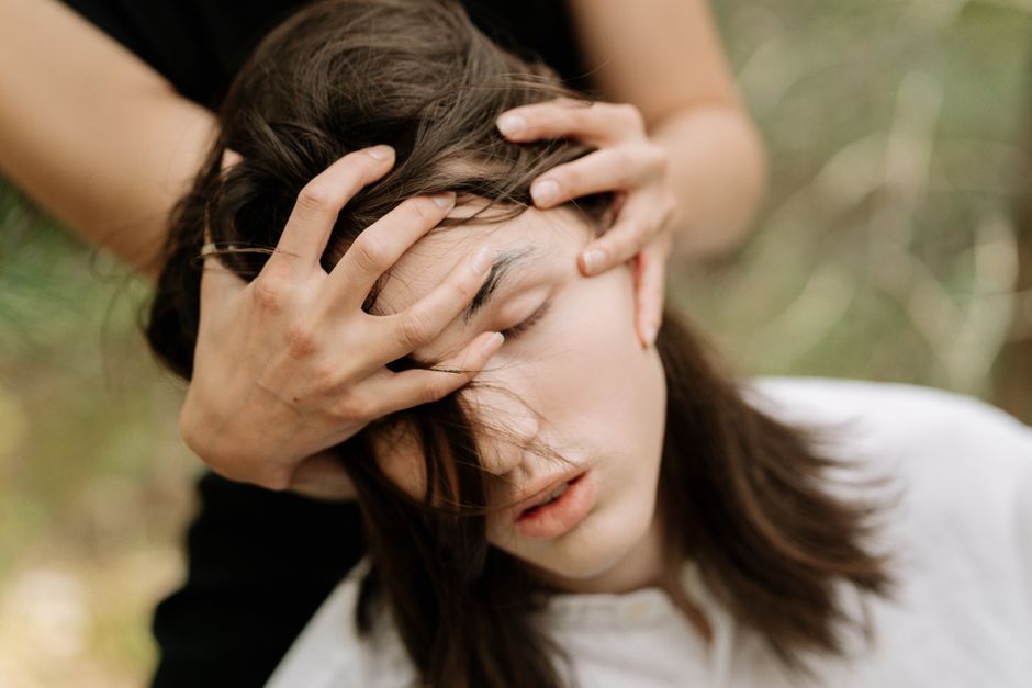 Person sitting calmly with eyes closed during a guided hypnosis session