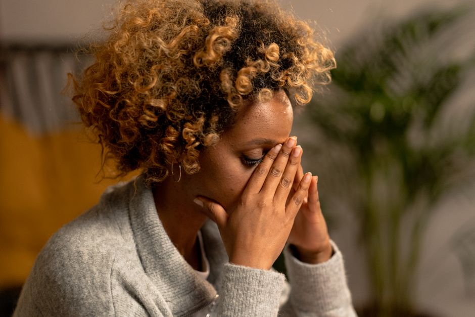 Close-up of a person holding their chest and breathing deeply during anxiety