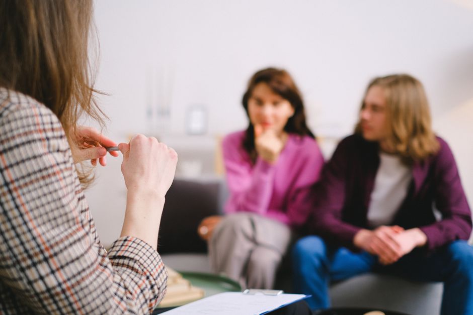 Couple in therapy session speaking with a counselor
