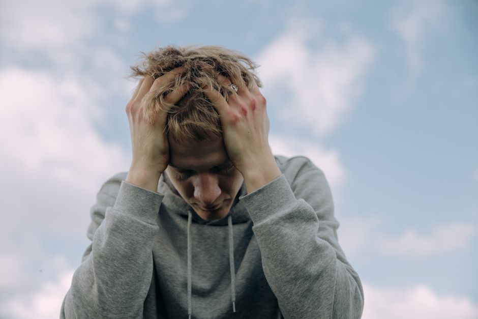 Close-up of a person holding their chest during a panic attack