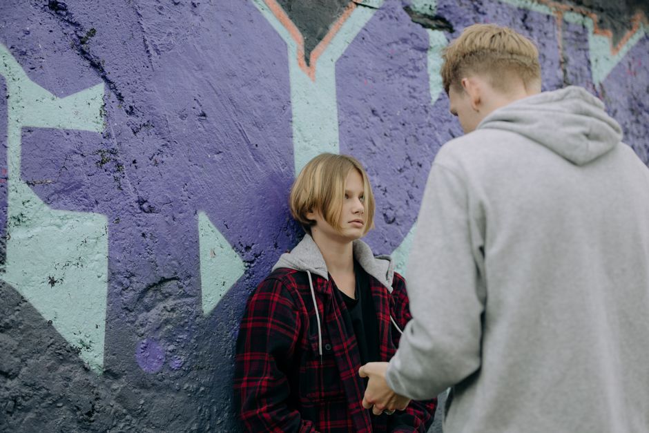 Teenage girl talking with her father outdoors