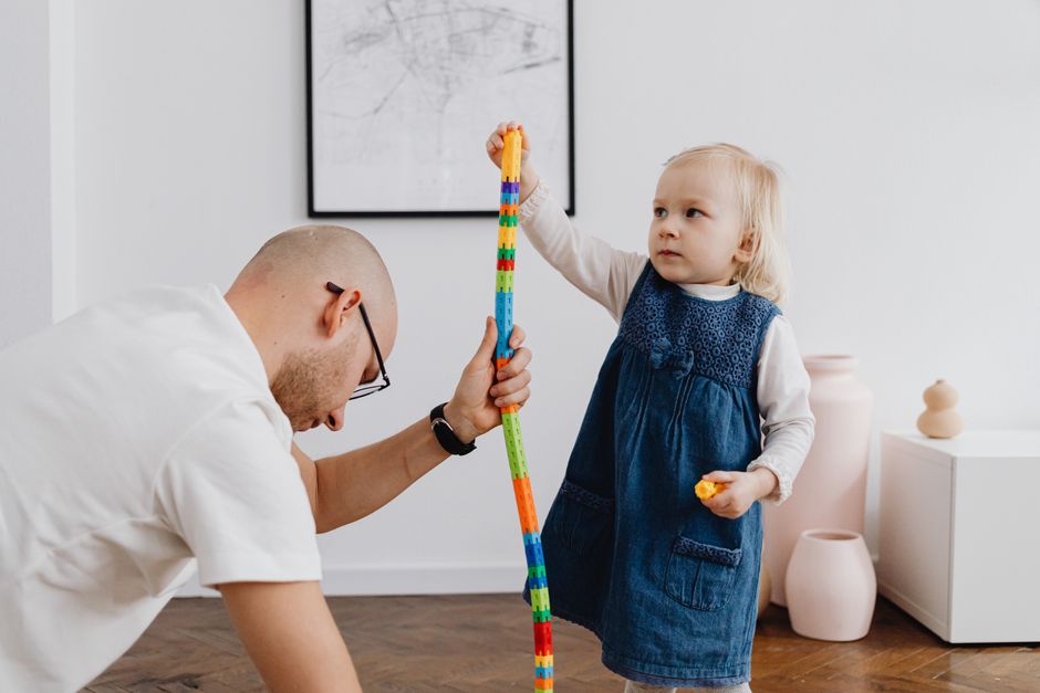 Father and daughter playing together on the floor