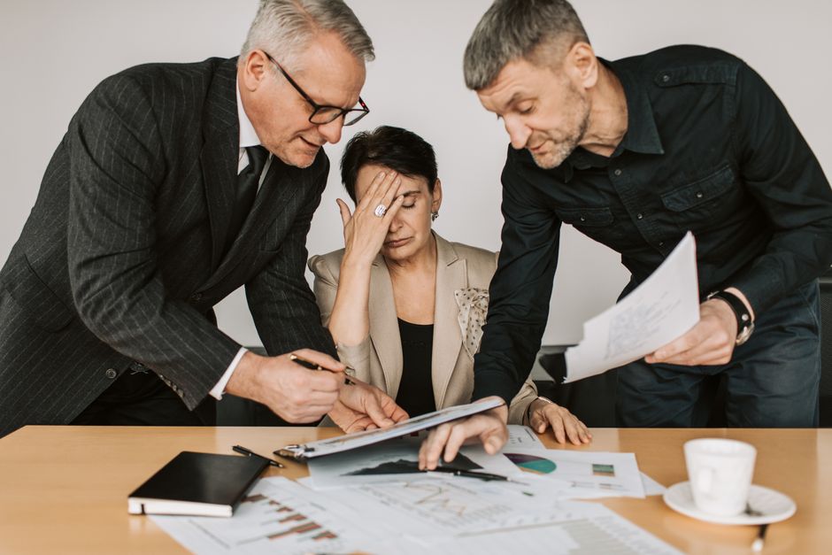 Person smiling at work while feeling overwhelmed