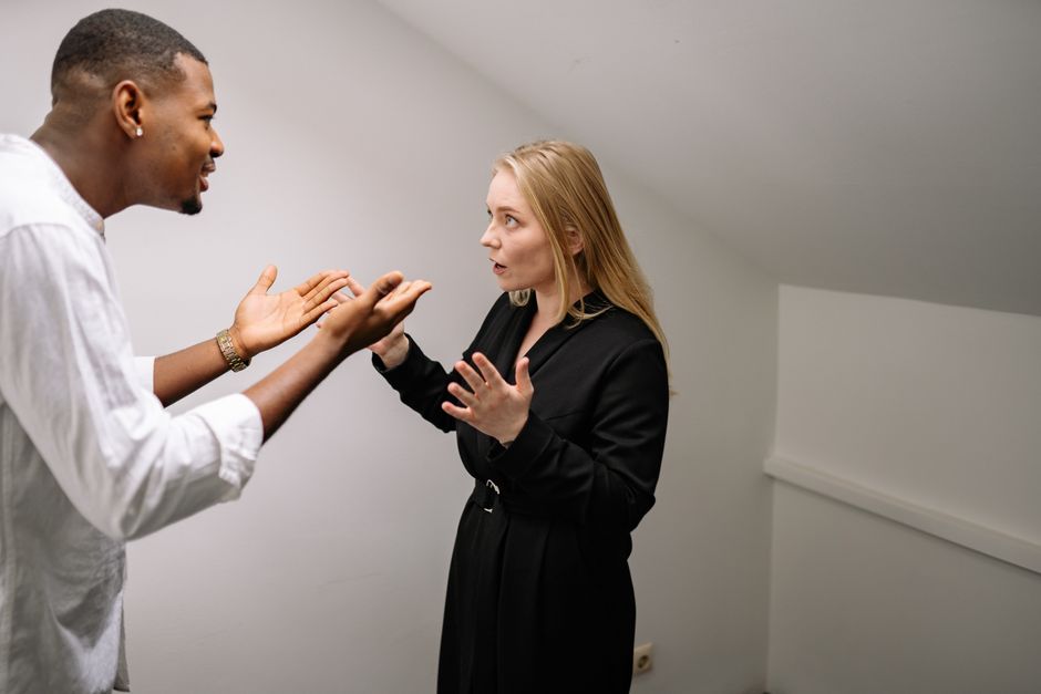 Two people in a tense conversation with one person setting a boundary