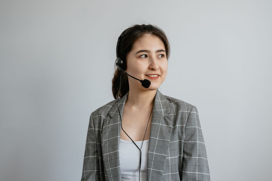 Woman holding phone with support hotline concept